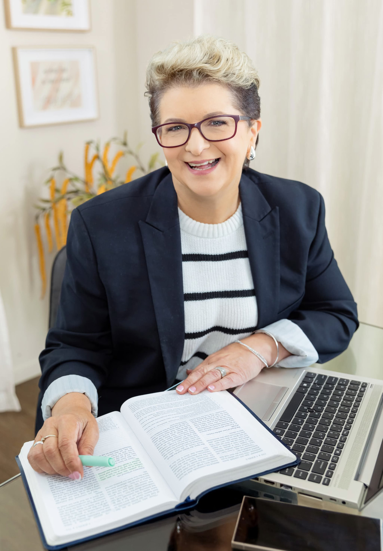 Lee-Ann Werner preparing teaching notes with an open Bible and laptop