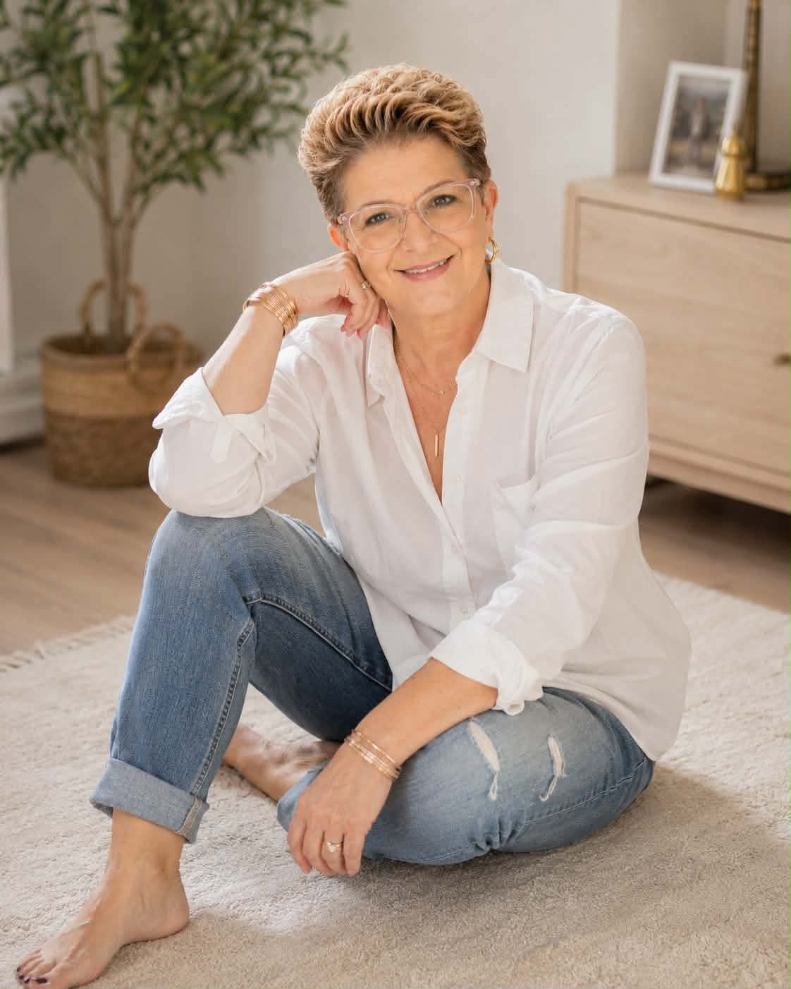 Lee-Ann Werner sitting on a rug in a bright, calm living room